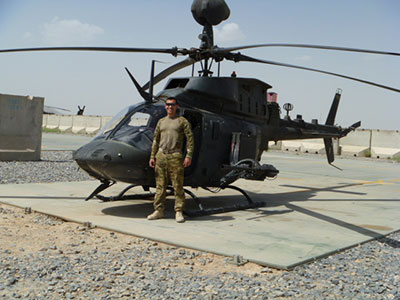 john leo in front of a helicopter