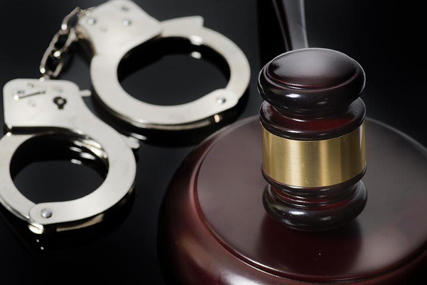 silver handcuffs and a gavel